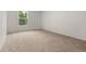 Well-lit bedroom with soft carpeting, a window, and neutral walls at 12671 E Bates Cir, Aurora, CO 80014