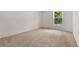 Bright bedroom with plush carpet, a view to outside, and neutral walls at 12671 E Bates Cir, Aurora, CO 80014