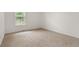 Bright bedroom with plush carpet, a view to outside, and neutral walls at 12671 E Bates Cir, Aurora, CO 80014