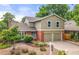 Charming two-story home with a well-manicured front yard, brick accents, and a two-car garage at 12671 E Bates Cir, Aurora, CO 80014