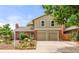 Charming two-story home featuring brick accents, a well-manicured yard, and an attached two-car garage at 12671 E Bates Cir, Aurora, CO 80014
