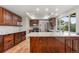 Spacious kitchen with stainless steel appliances, hardwood floors, and a large island at 12671 E Bates Cir, Aurora, CO 80014