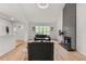 Bright living room with vaulted ceilings, a brick fireplace, and hardwood floors at 12671 E Bates Cir, Aurora, CO 80014