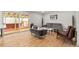 Bright living room featuring hardwood floors and sliding glass doors to the outdoor patio at 12671 E Bates Cir, Aurora, CO 80014