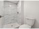 Modern shower with sleek, white, marble-look tile and a rainfall shower head at 12671 E Bates Cir, Aurora, CO 80014