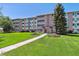 Attractive building exterior with landscaping and walkway at 715 S Alton Way # 5A, Denver, CO 80247