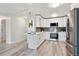 Bright kitchen with white cabinets, stainless steel appliances, and gray tile backsplash at 715 S Alton Way # 5A, Denver, CO 80247