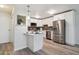 Bright kitchen features stainless steel appliances, white cabinetry, gray backsplash and stylish breakfast bar at 715 S Alton Way # 5A, Denver, CO 80247