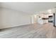 Bright living room with open concept kitchen and grey vinyl flooring at 715 S Alton Way # 5A, Denver, CO 80247