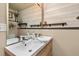 Bathroom featuring light wood vanity and a mirror over the sink at 7395 Heiter Hill Dr, Evergreen, CO 80439