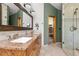 Bathroom with double sink vanity, granite countertop, walk-in shower, and closet with storage shelves at 7395 Heiter Hill Dr, Evergreen, CO 80439