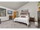 Comfortable bedroom with rustic accents, a cozy bed and natural light from the window at 7395 Heiter Hill Dr, Evergreen, CO 80439
