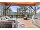 Relaxing deck area with outdoor seating, grill, and forested views at 7395 Heiter Hill Dr, Evergreen, CO 80439