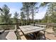 Outdoor dining table with wooded views at 7395 Heiter Hill Dr, Evergreen, CO 80439