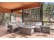 Outdoor deck area with seating, grill and metal privacy screen at 7395 Heiter Hill Dr, Evergreen, CO 80439