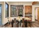 Bright dining room with an industrial light fixture, wooden table, and scenic outdoor views at 7395 Heiter Hill Dr, Evergreen, CO 80439