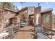 A beautiful home featuring multiple decks and outdoor dining area, perfect for entertaining and enjoying the outdoors at 7395 Heiter Hill Dr, Evergreen, CO 80439