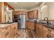 Modern kitchen with stainless steel appliances, dark countertops, and custom wood cabinetry at 7395 Heiter Hill Dr, Evergreen, CO 80439