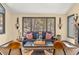 Cozy living room with a large window, comfortable seating, and decorative wall sconces at 7395 Heiter Hill Dr, Evergreen, CO 80439