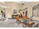 Open living room with neutral walls, ample seating, and a view of the hallway leading to the staircase at 7395 Heiter Hill Dr, Evergreen, CO 80439