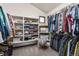 Large walk-in closet with built-in shelving, hanging rods, and window for natural light at 7395 Heiter Hill Dr, Evergreen, CO 80439
