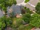 Aerial view of the home showcasing lush landscaping and a brick patio at 8953 W Brandt Pl, Littleton, CO 80123
