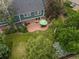 An aerial view displaying the home's brick patio and shaded backyard at 8953 W Brandt Pl, Littleton, CO 80123