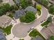 An aerial view shows a well-maintained neighborhood with mature trees and a green two-story home at 8953 W Brandt Pl, Littleton, CO 80123