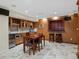 Finished basement wet bar area featuring custom cabinetry, seating, and natural lighting at 8953 W Brandt Pl, Littleton, CO 80123