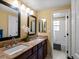 Elegant bathroom with double sinks, granite countertops, and a tub and shower combo at 8953 W Brandt Pl, Littleton, CO 80123