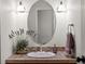 Powder bathroom boasts a decorative mirror, charming wall sconces and a decorative hand towel at 8953 W Brandt Pl, Littleton, CO 80123
