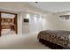 Carpeted bedroom with recessed lighting, walk-in closet, and easy access to a wet bar at 8953 W Brandt Pl, Littleton, CO 80123