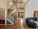 Inviting entryway featuring a staircase with wooden banister and chandelier, leading to the upper level at 8953 W Brandt Pl, Littleton, CO 80123