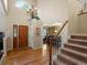 Elegant foyer with hardwood floors, a grand staircase, and a view into the dining room at 8953 W Brandt Pl, Littleton, CO 80123