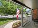 View from the porch of a charming home with American flag and mature landscaping at 8953 W Brandt Pl, Littleton, CO 80123