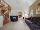 Bright living room with vaulted ceiling, neutral carpet, comfortable seating, and lots of natural light at 8953 W Brandt Pl, Littleton, CO 80123