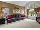 Spacious living room featuring large windows and a comfortable sofa perfect for entertaining guests at 8953 W Brandt Pl, Littleton, CO 80123