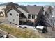 A bird's eye perspective of a gray home with a deck and a patio set on a lush lawn at 3008 Mountain Sky Dr, Castle Rock, CO 80104