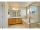 Bathroom with double vanity and soaking tub at 3008 Mountain Sky Dr, Castle Rock, CO 80104