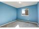 Blue bedroom with a window and grey carpet at 3008 Mountain Sky Dr, Castle Rock, CO 80104