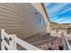 Landscaped side yard with a pathway, rock border, and a white fence at 3008 Mountain Sky Dr, Castle Rock, CO 80104