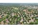 Aerial view of a neighborhood with tree-lined streets and homes on a sunny day at 6514 Zinnia St, Arvada, CO 80004