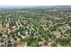 Aerial view showcases a peaceful residential area with green spaces and tree-lined streets at 6514 Zinnia St, Arvada, CO 80004