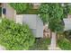 Aerial view of the home showing its roof, backyard patio, and gravel area and surrounding trees at 6514 Zinnia St, Arvada, CO 80004