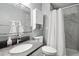 Bathroom featuring gray countertops, and white cabinets with a shower with tile surround at 6514 Zinnia St, Arvada, CO 80004