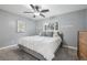 Serene bedroom with soft gray walls, plush carpeting, and a large window providing natural light at 6514 Zinnia St, Arvada, CO 80004