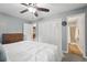 Comfortable bedroom featuring plush carpets, a ceiling fan, and ensuite bath access, great for a primary suite at 6514 Zinnia St, Arvada, CO 80004