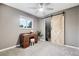 Charming bedroom with window, ceiling fan and rustic barn door at 6514 Zinnia St, Arvada, CO 80004