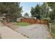Gravel parking area next to a fenced yard, showing a corner of the house at 6514 Zinnia St, Arvada, CO 80004