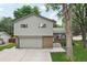 Two story home featuring brick accents, a gray front door, garage, and front walkway at 6514 Zinnia St, Arvada, CO 80004